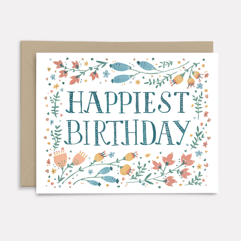 birthday card hand lettered with "happiest birthday" text and floral design